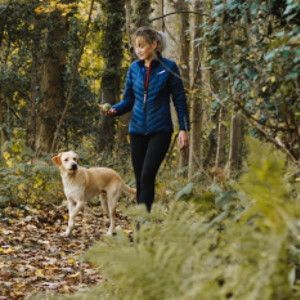 image of woman walking her dog